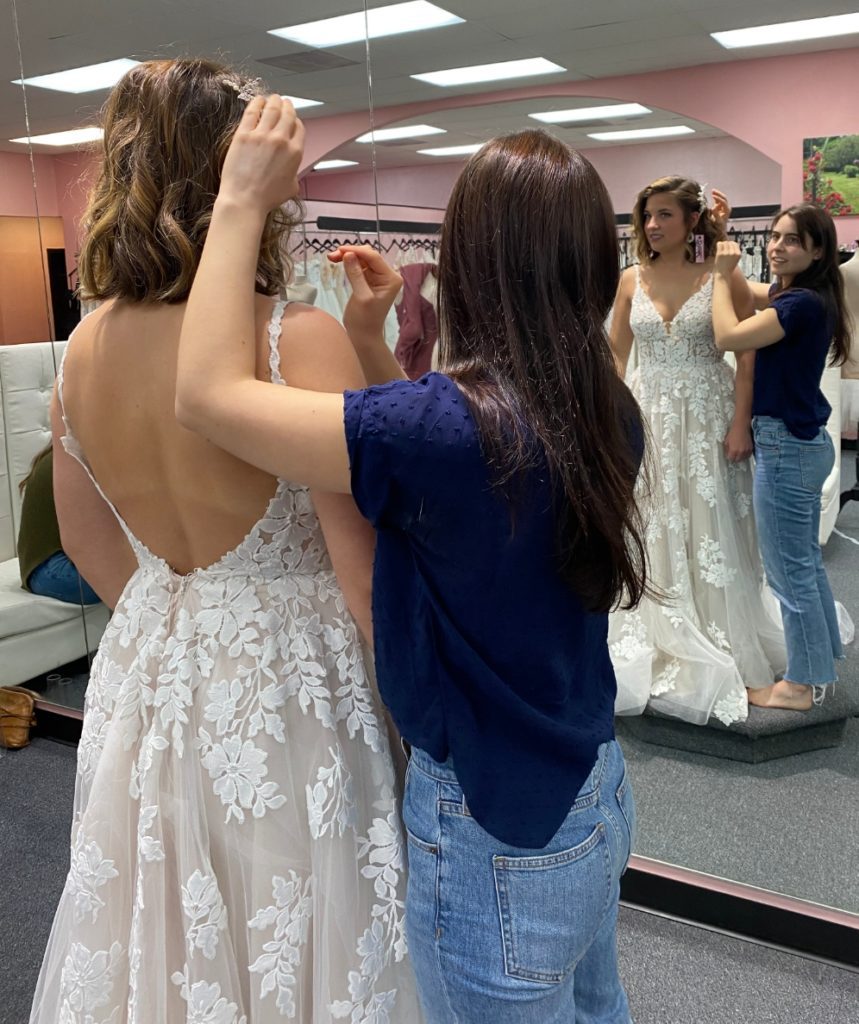 bride trying on bridal gown in store