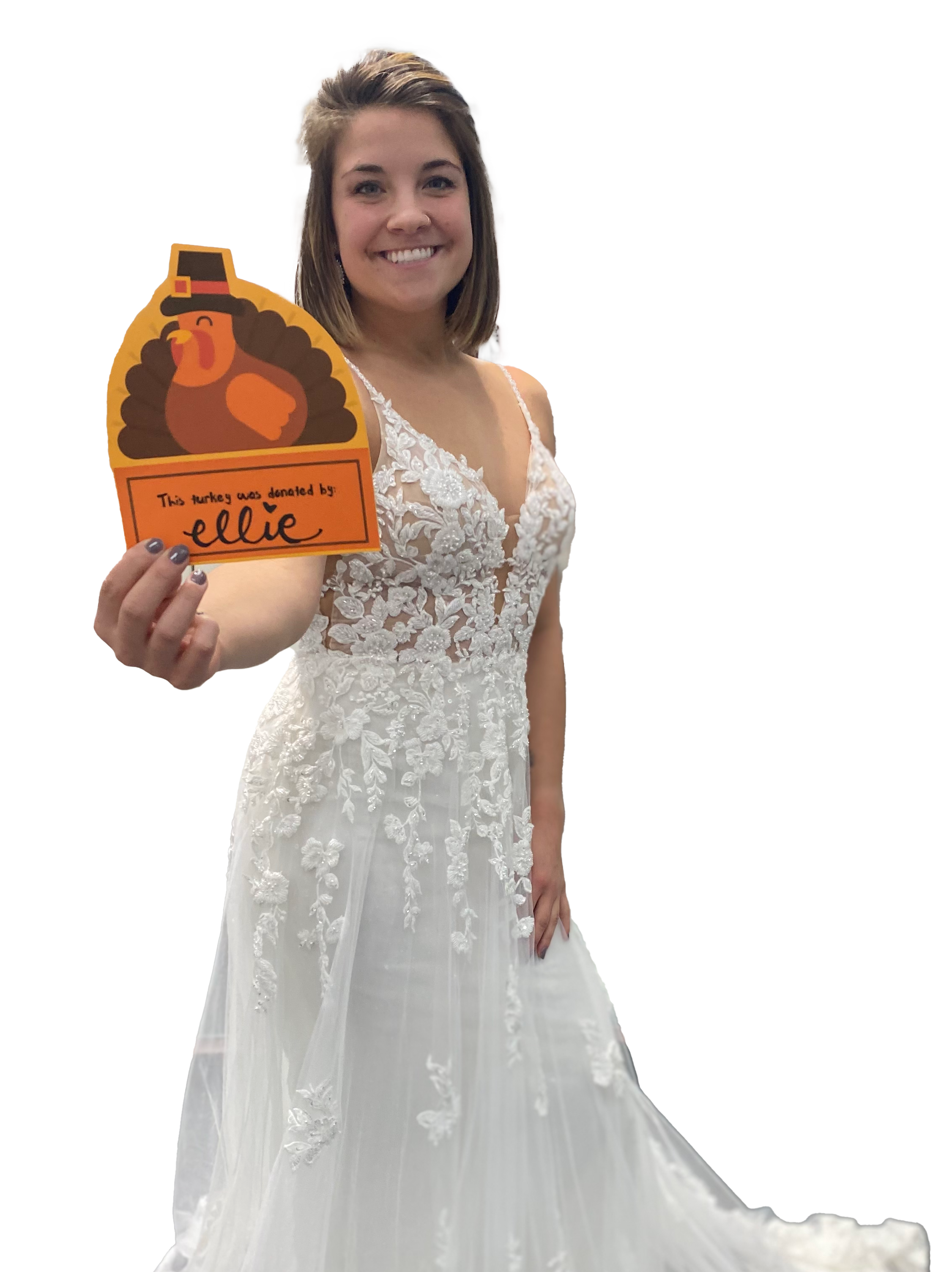 smiling brdie in white bridal gown holding a card saying "This turkey was donated by Ellie"