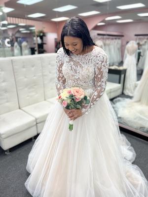 bride overjoyed wearing laced wedding gown